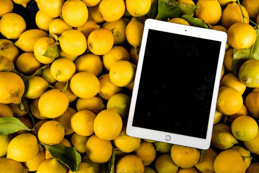 Ipad laying on top of pile of lemons