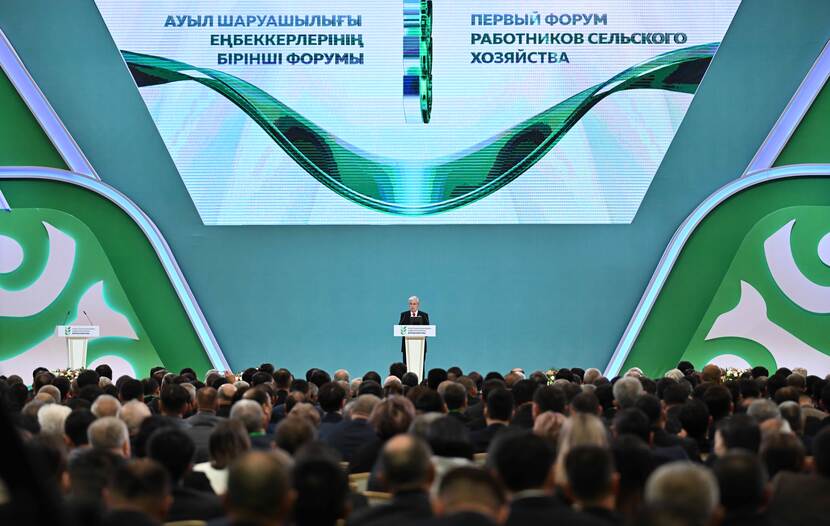 President Tokayev standing on stage from a distance