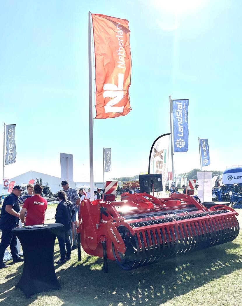 agricultural machine with a Dutch flag above it.